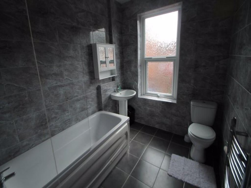 A modern bathroom suite featuring a full bathtu...
