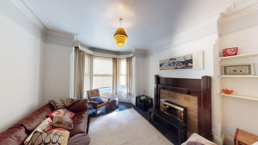 A charming living room featuring a cozy firepla...