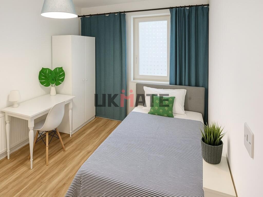 A bright and tidy bedroom featuring a comfortab...
