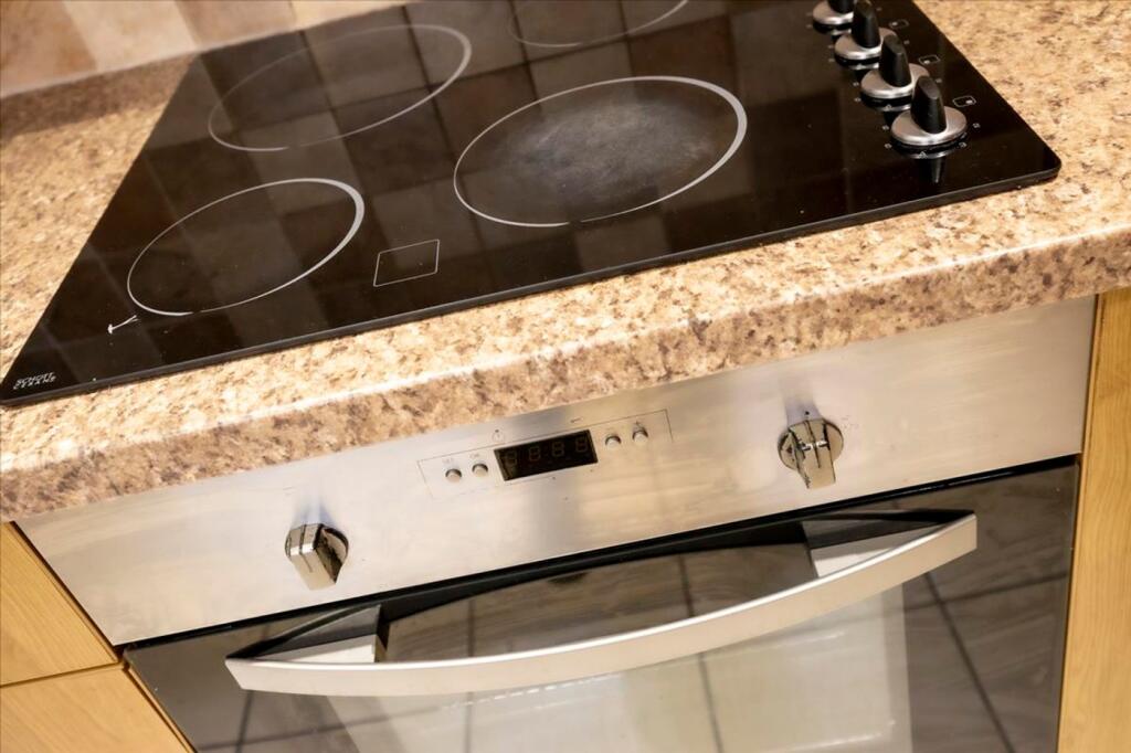 A modern kitchen featuring a sleek countertop w...