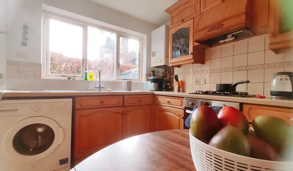 Bright and inviting kitchen featuring warm wood...