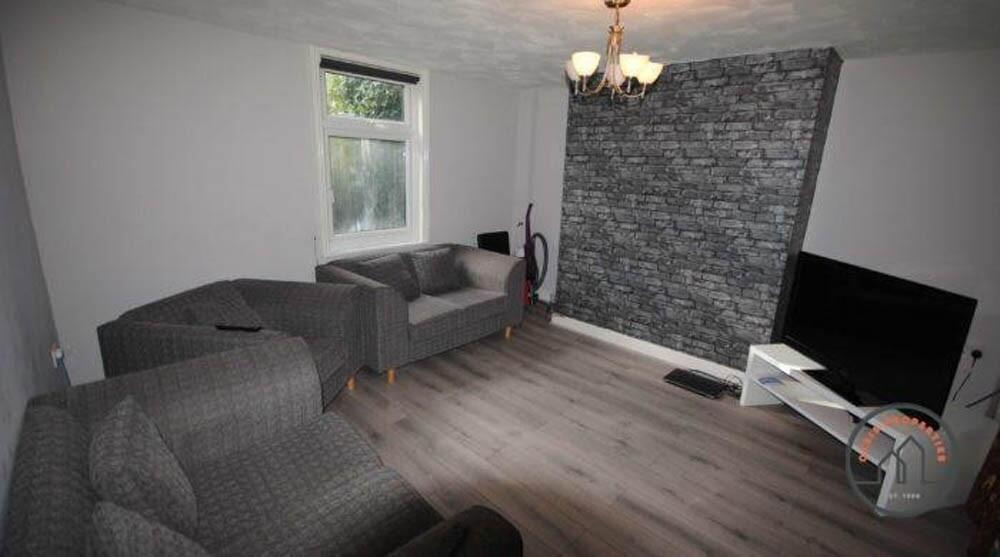 A cozy living room featuring modern grey sofas,...