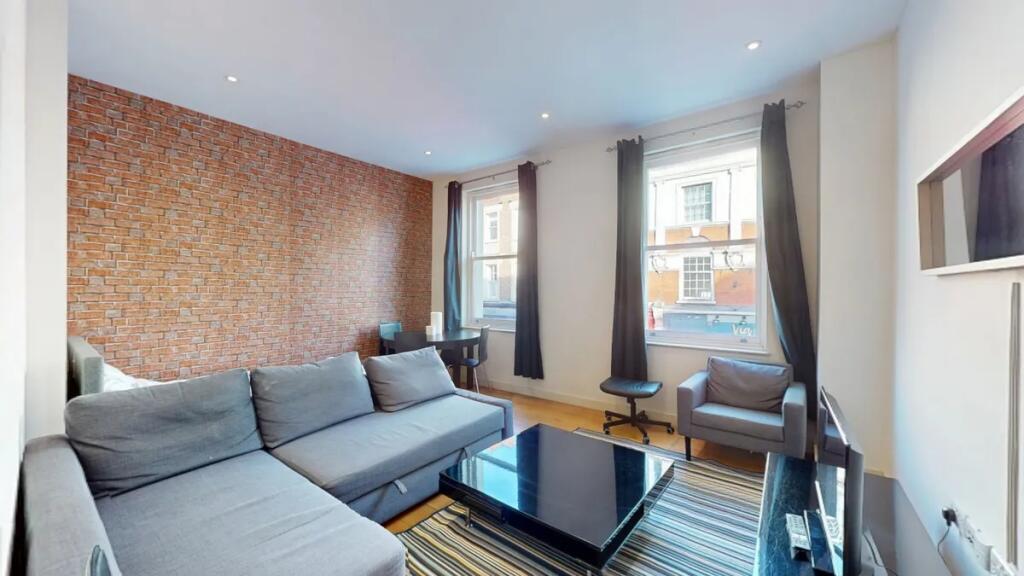 Bright and modern living room featuring a styli...