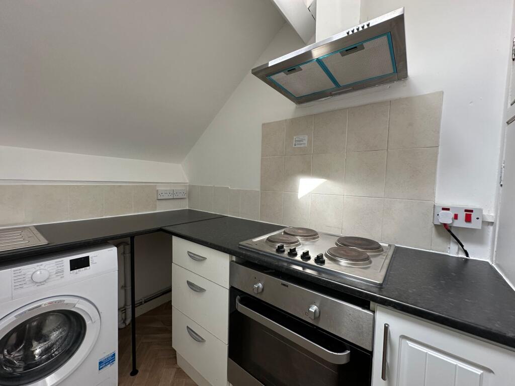 Bright and tidy kitchen featuring modern applia...