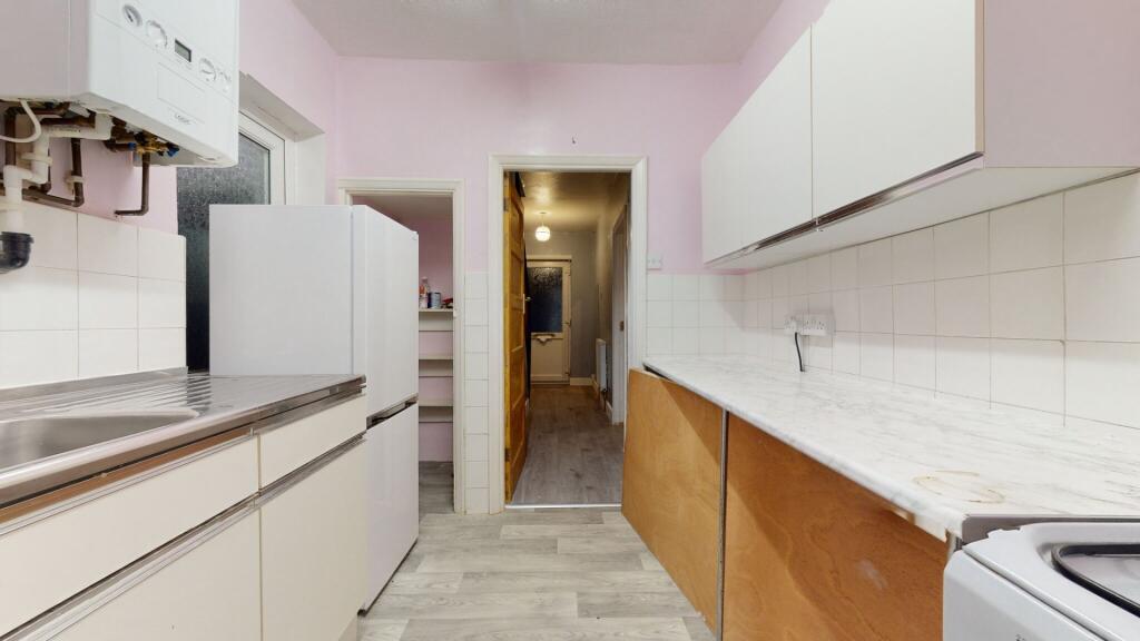 A neat and functional kitchen featuring clean c...