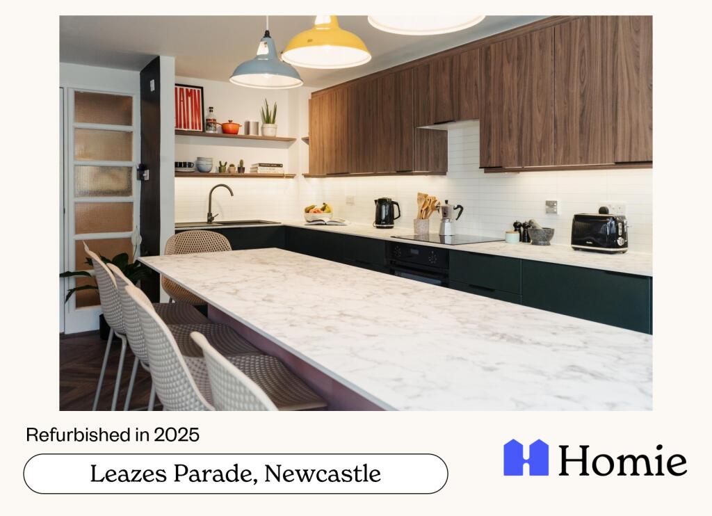 A spacious and modern kitchen with ample counte...