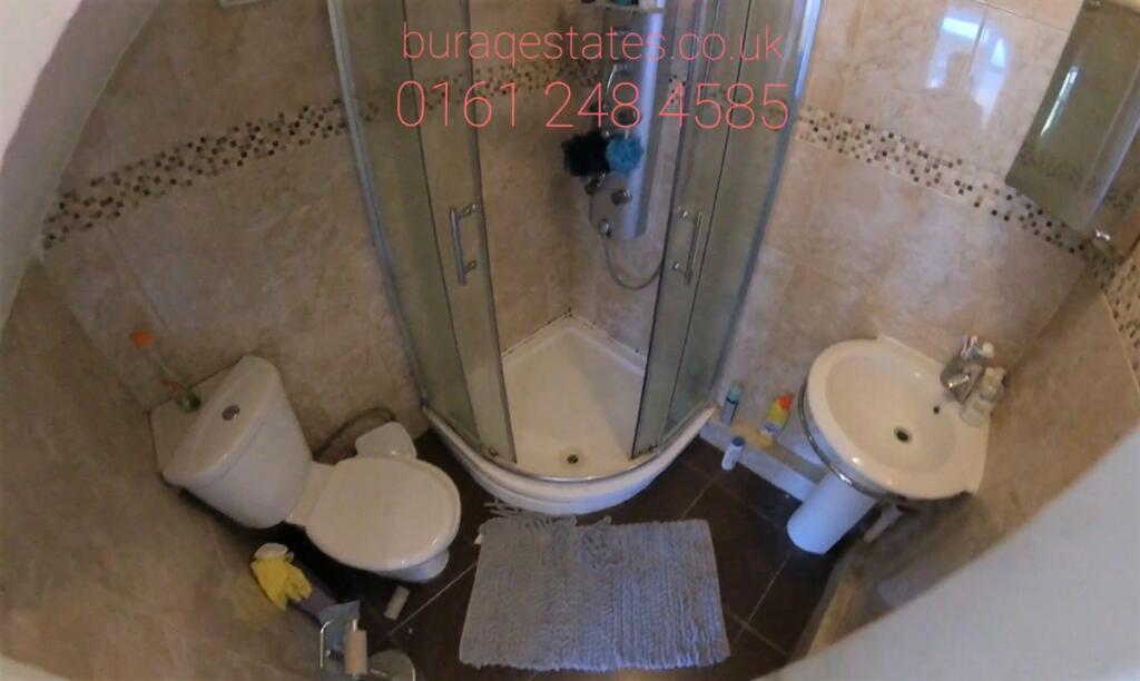 Compact, well-maintained bathroom with a corner...