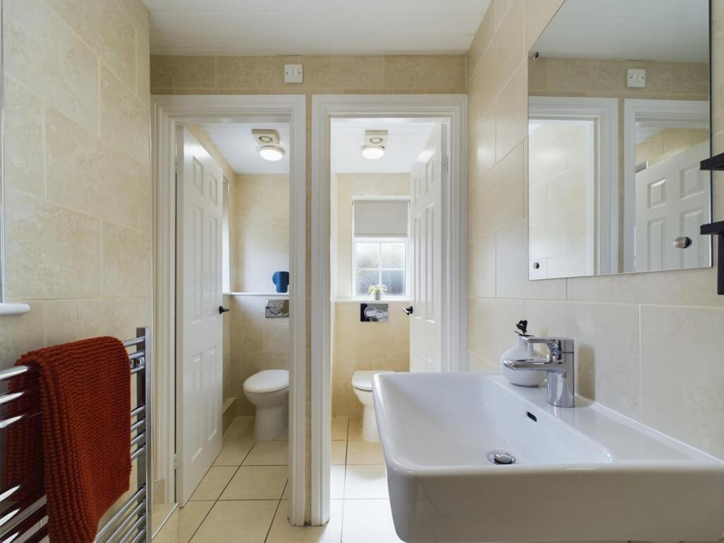 A spacious and well-maintained large bathroom f...
