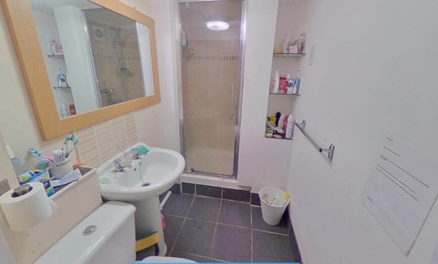 A clean and functional bathroom featuring a wal...