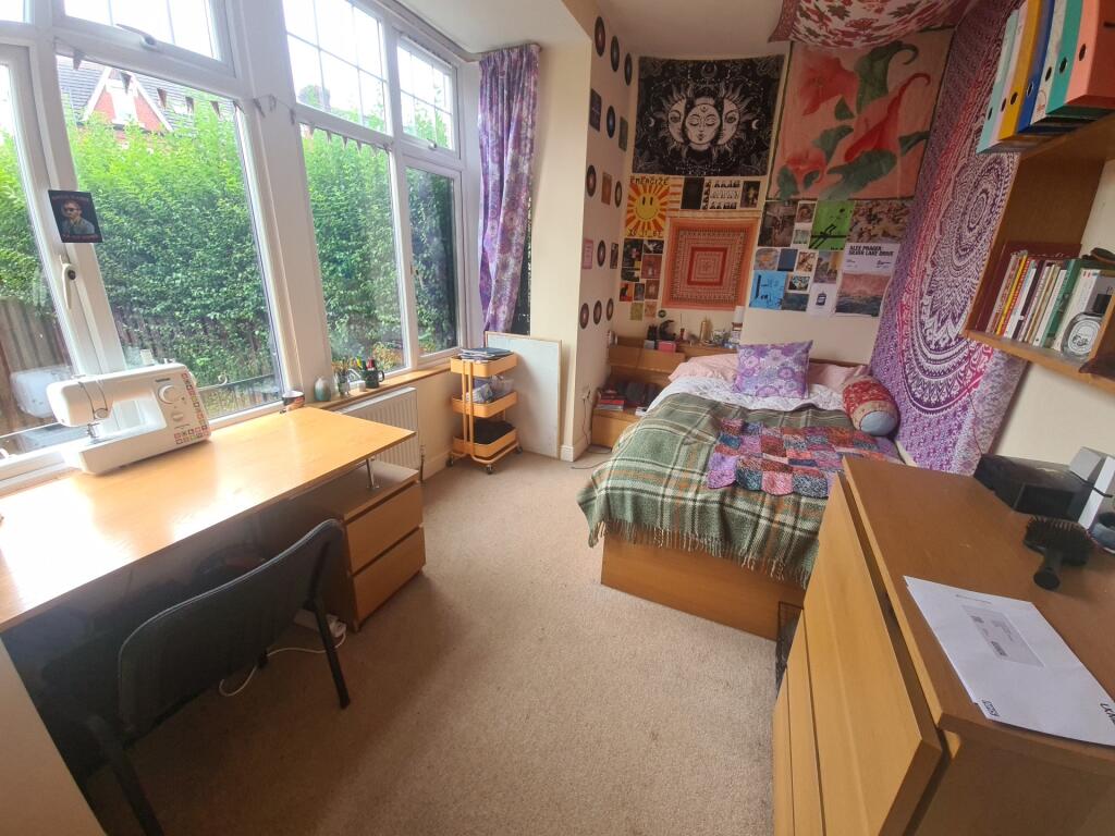 Bright and cozy single bedroom with a large win...