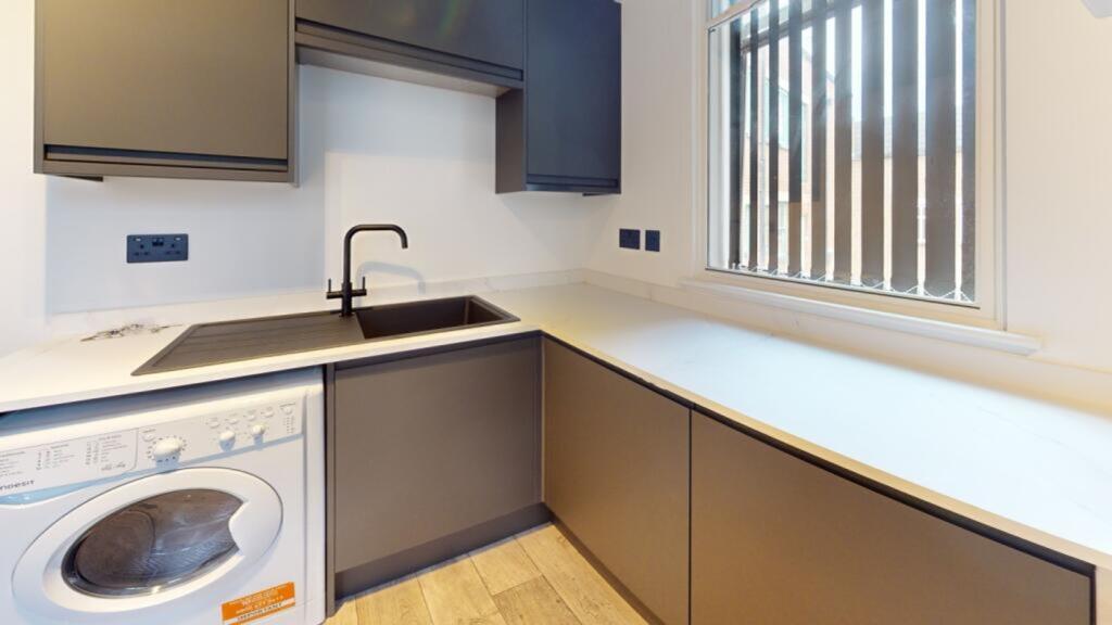A modern kitchenette featuring sleek cabinetry ...