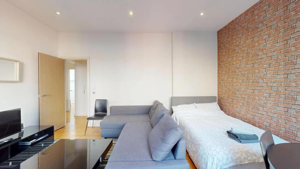 Bright and modern double bedroom featuring a st...