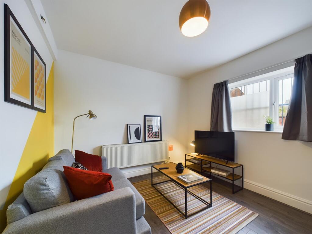 A bright and inviting large modern living room,...