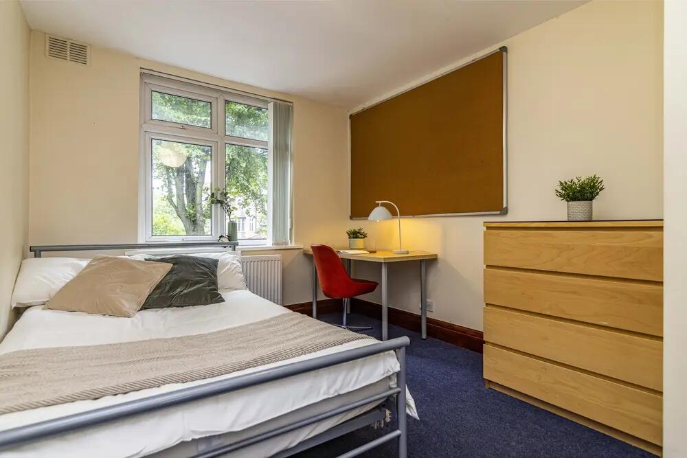 A bright and inviting double bedroom featuring ...