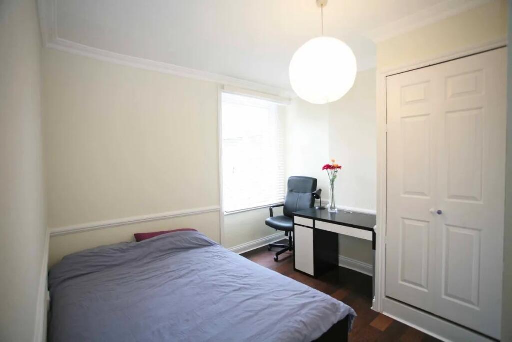 Bright and tidy double bedroom featuring a comf...