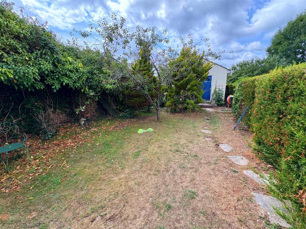 Rear lawn and garden room.jpg