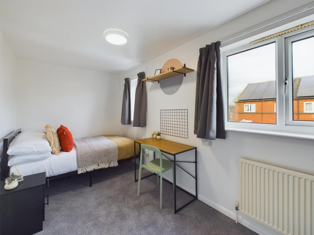A bright and inviting double bedroom with moder...