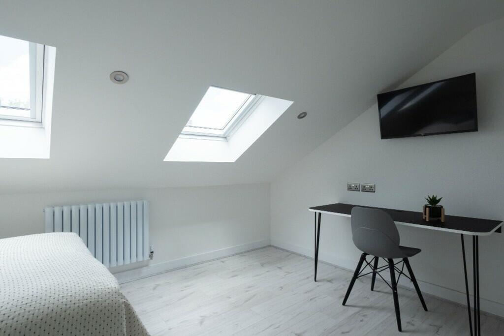 A bright and spacious double bedroom featuring ...