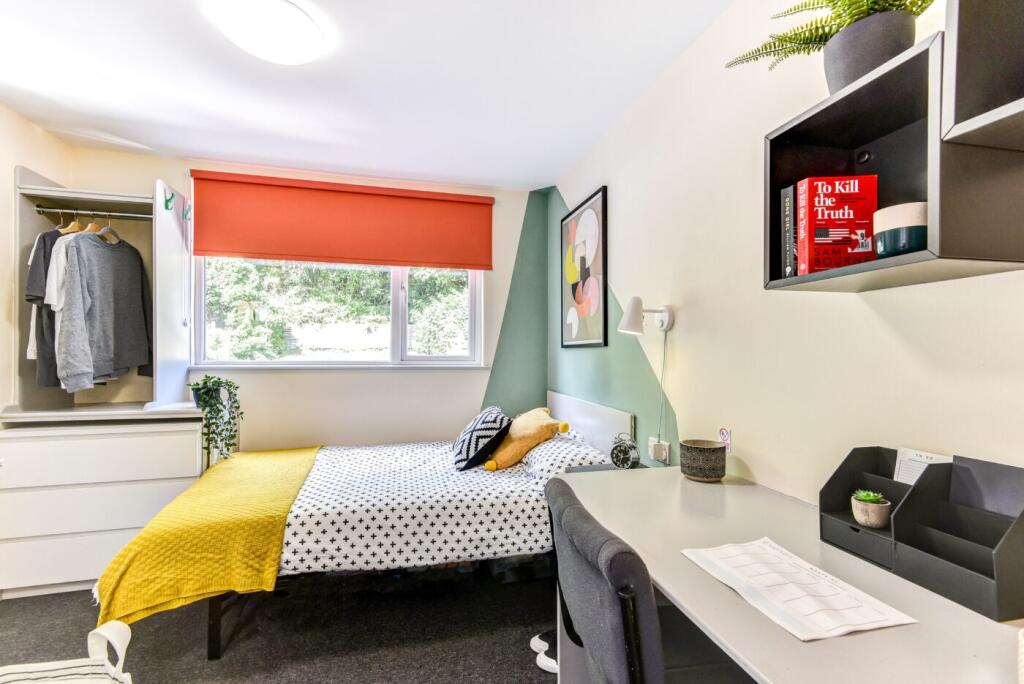 Bright, well-styled bedroom with a comfortable ...