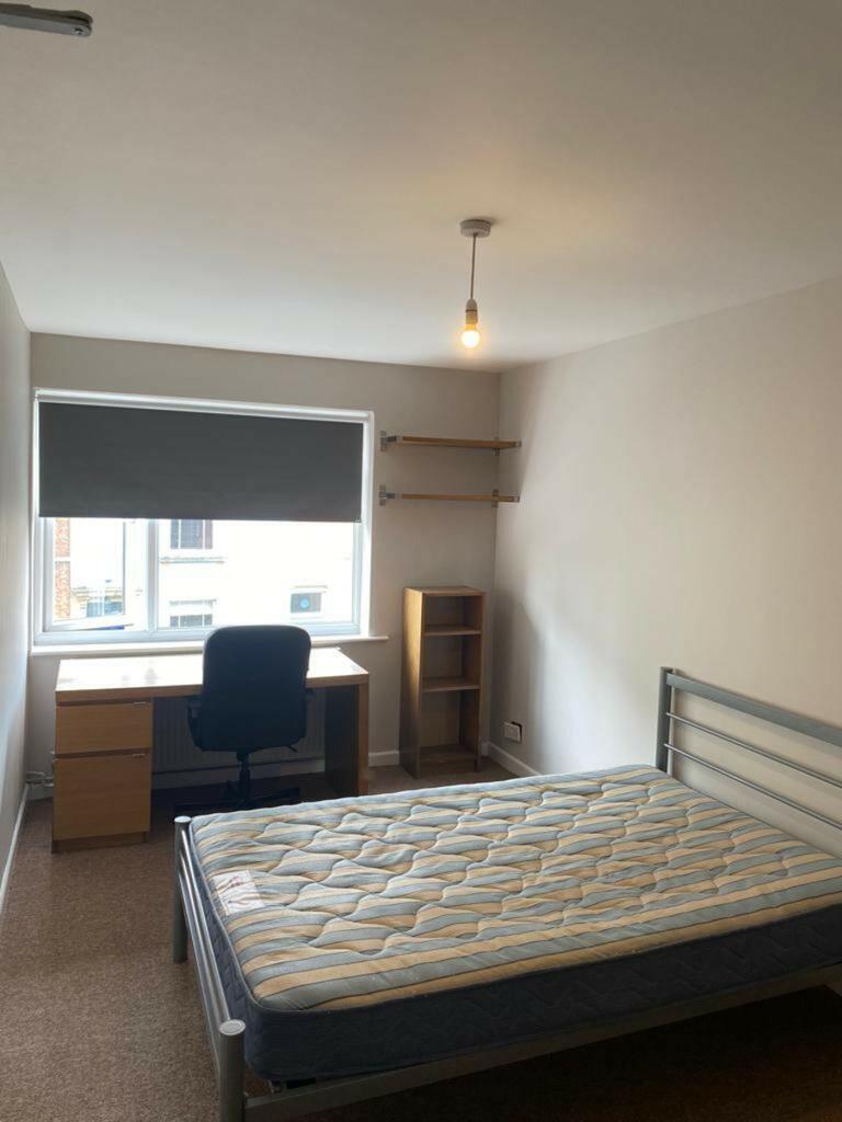 Bright and spacious double bedroom featuring a ...