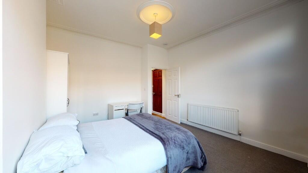 Bright and spacious master bedroom featuring a ...