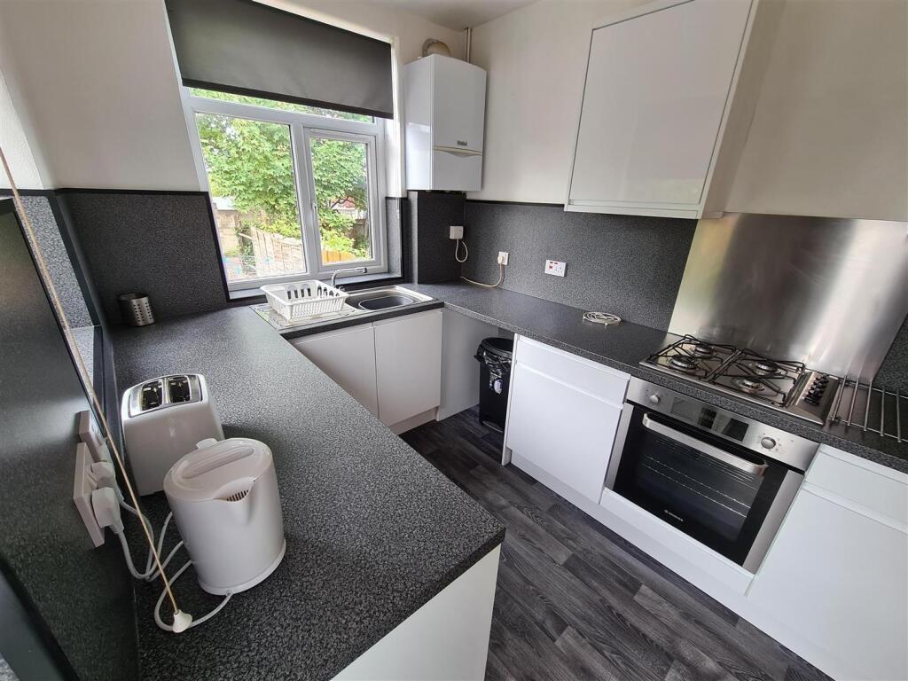 Modern kitchen featuring sleek cabinetry and am...