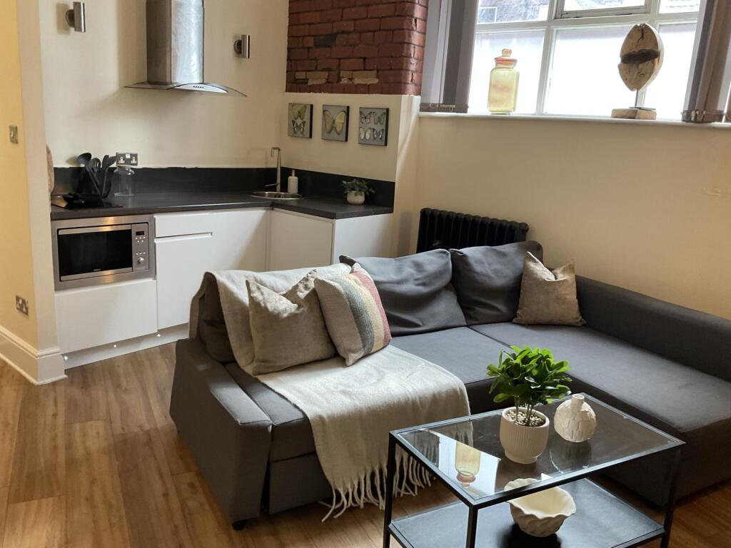 A cozy and modern living room featuring a comfo...