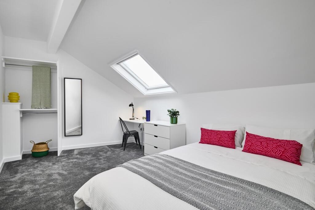 Bright and spacious master bedroom featuring a ...