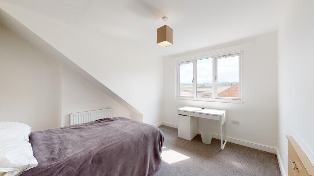 A neat and bright single bedroom featuring a co...