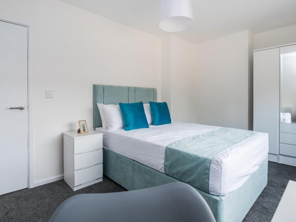 Bright and tidy double bedroom featuring a comf...