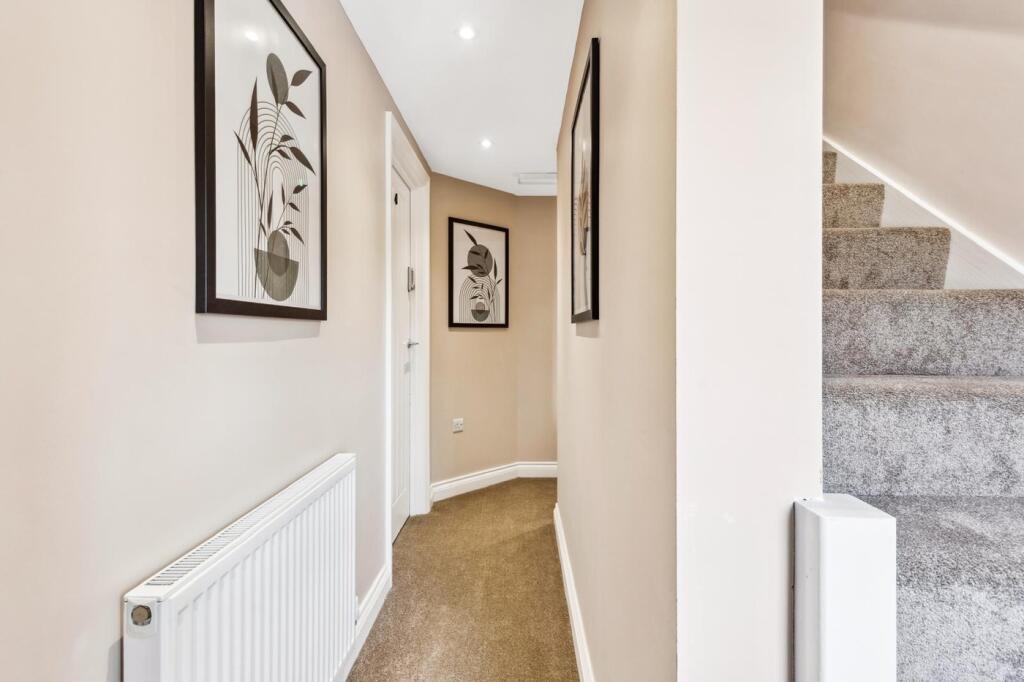 A stylish hallway adorned with modern artwork, ...