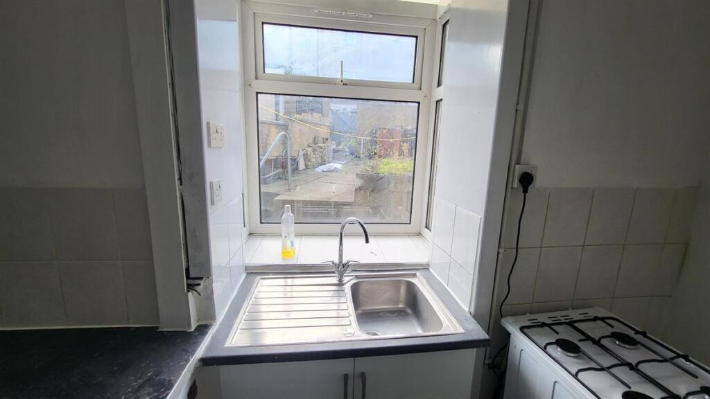 Compact kitchen with a stainless-steel sink and...