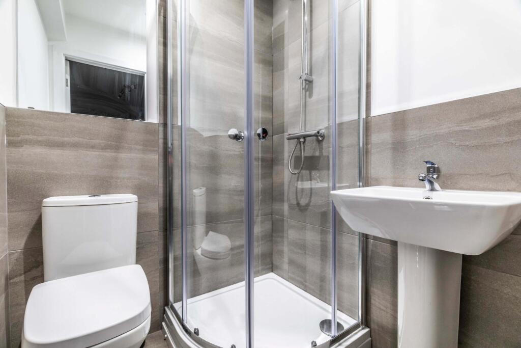 Modern and clean bathroom with a spacious showe...