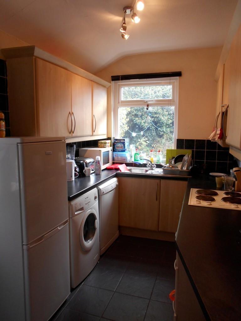 Compact kitchen space featuring modern applianc...