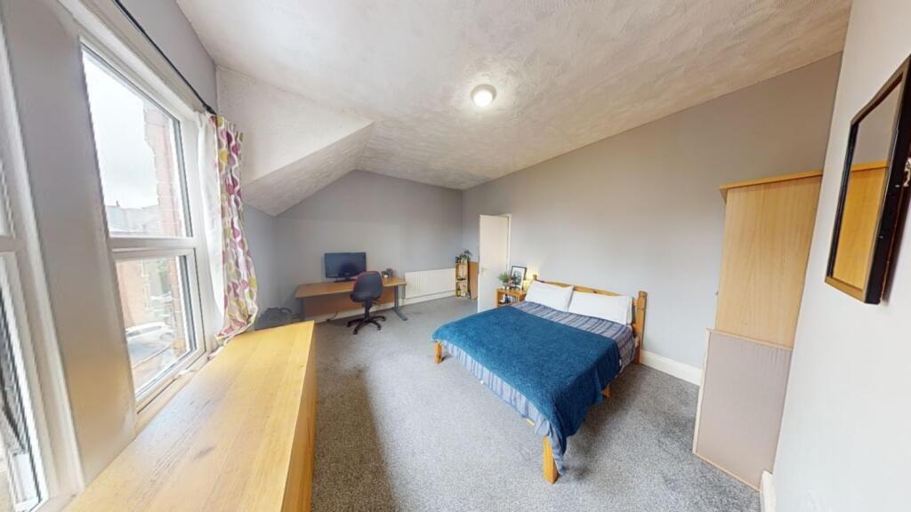 A bright and inviting double bedroom featuring ...