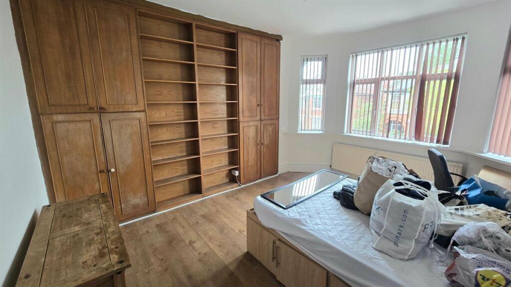 Bright double bedroom with large built-in woode...