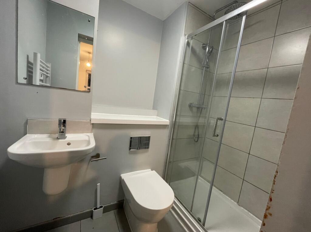 A modern bathroom featuring a walk-in shower wi...