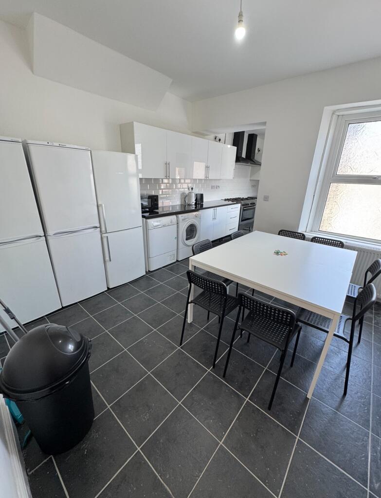 Bright and modern kitchen featuring ample cabin...