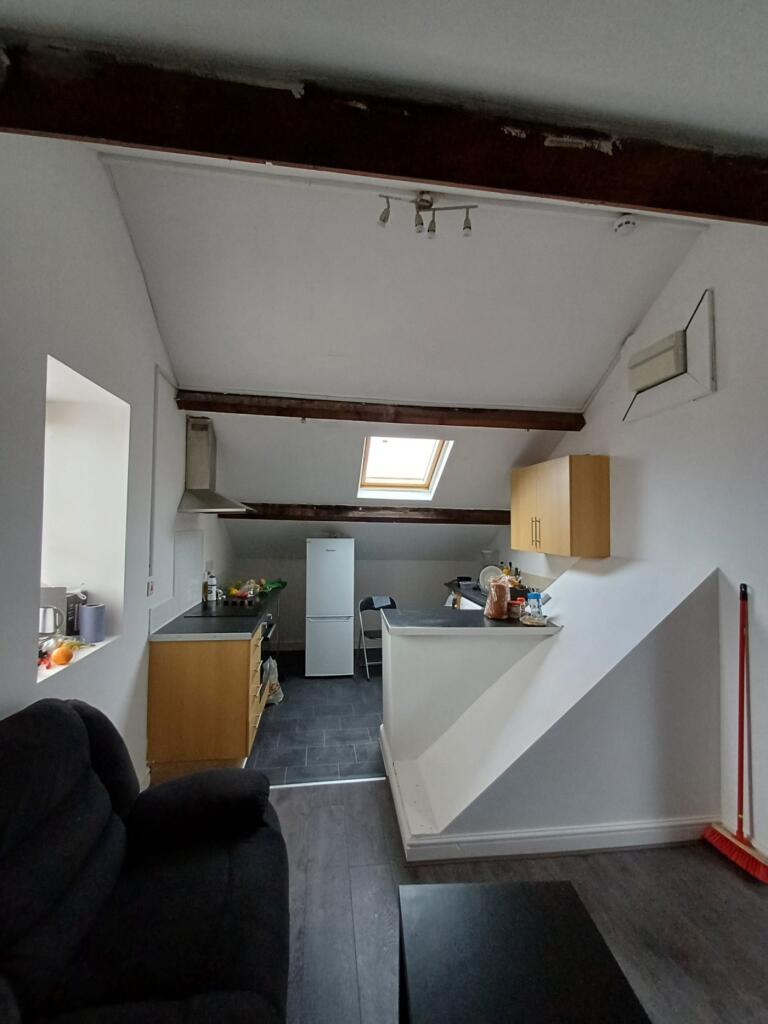 A modern kitchen featuring sleek cabinetry and ...