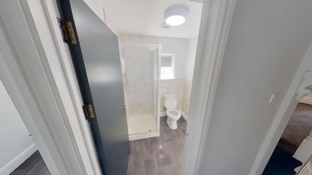 A clean and modern bathroom featuring a shower ...