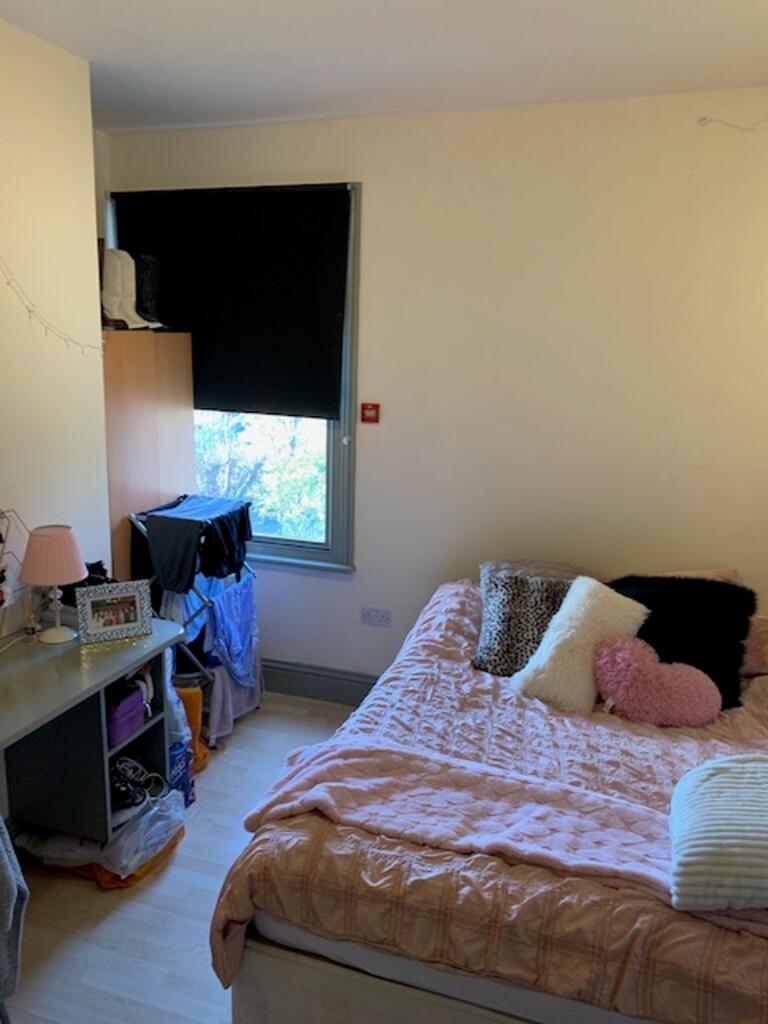 A cozy double bedroom featuring ample natural l...