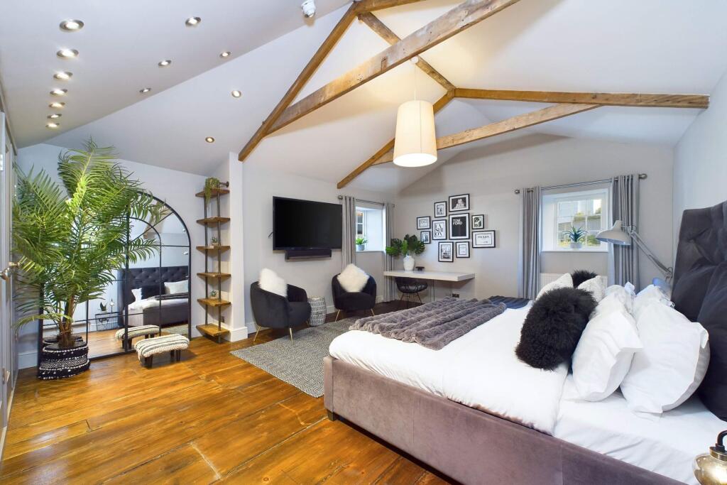 Bedroom five with vaulted ceiling