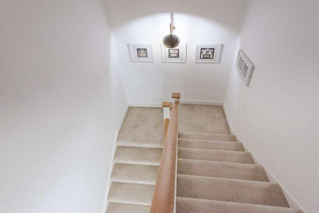 INNER APARTMENT ENTRANCE AND STAIRWELL TO BEDROOMS