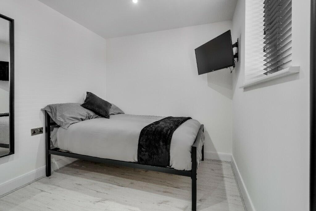 A modern and tidy double bedroom featuring a st...