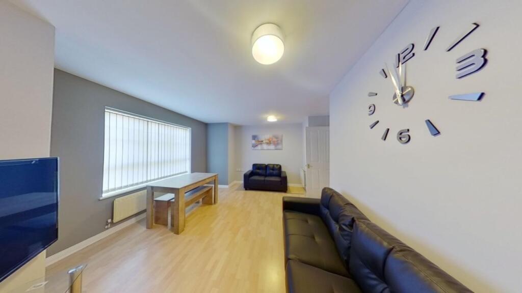 A bright and spacious living room featuring mod...