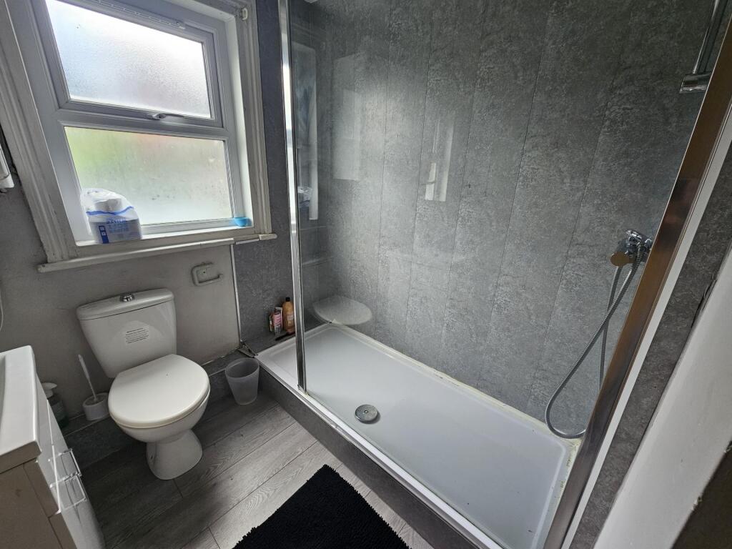 Modern bathroom with white suite, combined bath...
