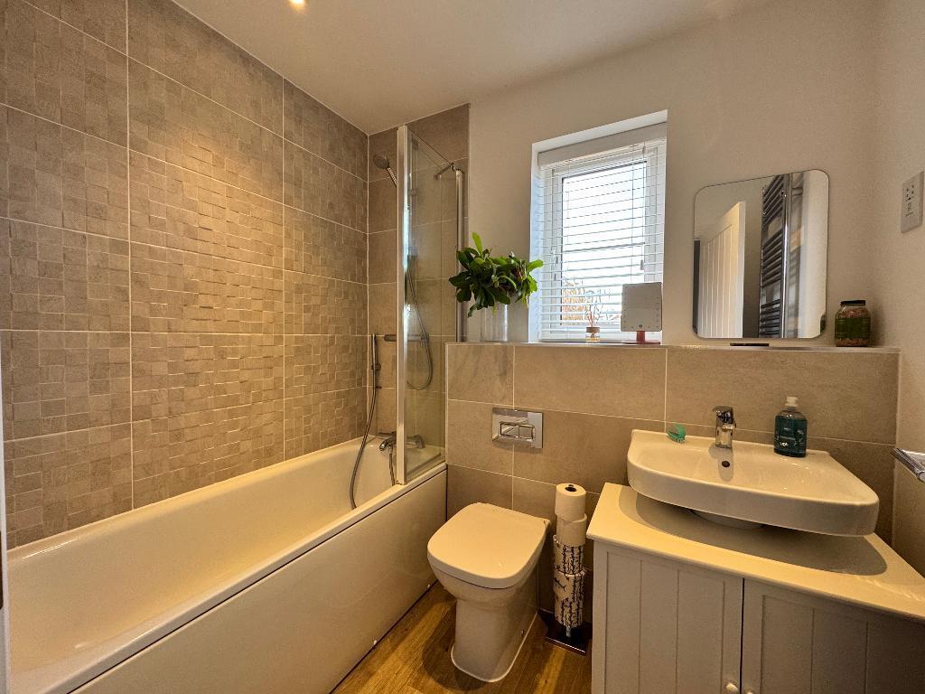 Family bathroom with shower over
