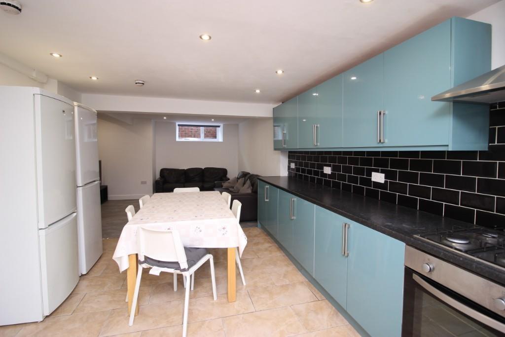 A modern kitchen with sleek turquoise cabinets ...