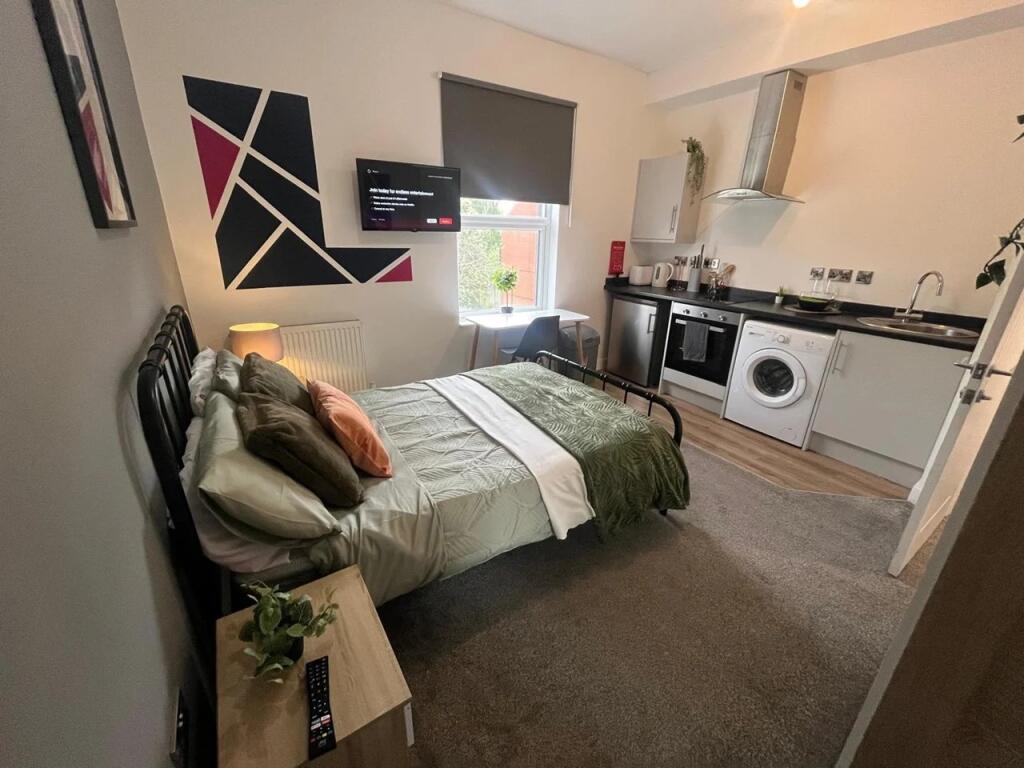 A cozy double bedroom with a comfortable bed, a...