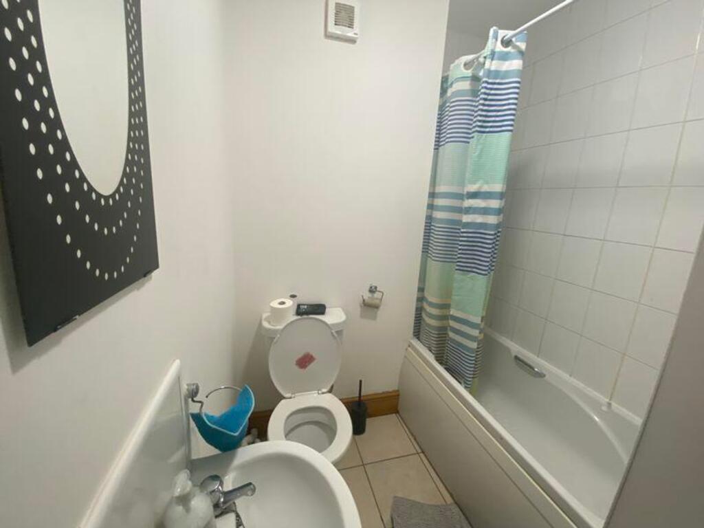A tidy bathroom featuring a bathtub and modern ...